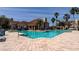 Resort-style pool with palm trees, lounge chairs, and a clubhouse, perfect for relaxation and community gatherings at 17965 Villa Creek Dr, Tampa, FL 33647