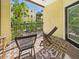Cozy balcony with outdoor seating and garden view, perfect for relaxing and enjoying the fresh air at 1810 E Palm Ave # 6104, Tampa, FL 33605