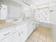 Bright bathroom featuring double sinks with white cabinets and tiled floors at 1810 E Palm Ave # 6104, Tampa, FL 33605
