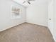 A well-lit bedroom with wall-to-wall carpet features a ceiling fan and an exterior window at 1810 E Palm Ave # 6104, Tampa, FL 33605