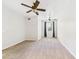A large room with wall-to-wall carpeting features dual ceiling fans and an exterior window at 1810 E Palm Ave # 6104, Tampa, FL 33605