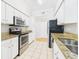 Well-lit kitchen with white cabinets, granite countertops, and stainless steel appliances at 1810 E Palm Ave # 6104, Tampa, FL 33605