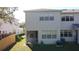 Back exterior view with a screened porch, manicured lawn, and privacy fence at 19227 Stone Hedge Dr, Tampa, FL 33647