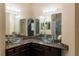 Bathroom featuring dual glass vessel sinks, granite countertops, and decorative vanity mirror at 19227 Stone Hedge Dr, Tampa, FL 33647