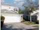 Charming home featuring a two-car garage, stone accents, and well-maintained landscaping at 19227 Stone Hedge Dr, Tampa, FL 33647