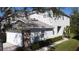 Two-story home featuring a two-car garage, stone accents, and manicured front lawn at 19227 Stone Hedge Dr, Tampa, FL 33647