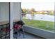 Balcony featuring outdoor seating and a grill, overlooking a serene water view and grassy backyard at 19279 Stone Hedge Dr, Tampa, FL 33647