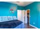 This bedroom features blue walls, hardwood floors, decor, and access to a walk-in closet at 19279 Stone Hedge Dr, Tampa, FL 33647