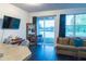 Living room with contemporary decor, large sofa, and sliding glass doors leading to the balcony and water view at 19279 Stone Hedge Dr, Tampa, FL 33647