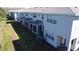A back view of the townhomes shows screened patios and an expanse of lawn space at 19279 Stone Hedge Dr, Tampa, FL 33647