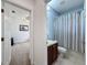 The cozy bathroom features a shower with striped curtain and a single sink at 20352 Falling Rock Dr, Land O Lakes, FL 34638