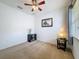 A cozy bedroom features neutral carpet, ceiling fan and decorative wall art, all bathed in natural light from the window at 20352 Falling Rock Dr, Land O Lakes, FL 34638