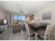 Bright living room with a ceiling fan and sliding glass doors leading to a balcony with scenic views at 320 Island Way # 102, Clearwater Beach, FL 33767