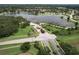Aerial view of the community, showing a large pond, gazebo, and meticulously landscaped entrance at 3217 Partridge Point Trl, Valrico, FL 33596