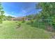 Home exterior, showing a very large, well manicured backyard with healthy green grass and trees at 3217 Partridge Point Trl, Valrico, FL 33596