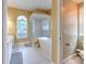 Bright bathroom featuring a large window, glass shower, and soaking tub at 3217 Partridge Point Trl, Valrico, FL 33596