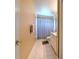Clean bathroom featuring tile floors, striped shower curtain, vanity and neutral walls at 3217 Partridge Point Trl, Valrico, FL 33596