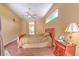 Comfortable bedroom with wood-look tile floors, ceiling fan, and natural light at 3217 Partridge Point Trl, Valrico, FL 33596