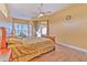Inviting bedroom with tile floors, ceiling fan, plenty of natural light, and backyard access at 3217 Partridge Point Trl, Valrico, FL 33596