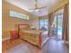 Relaxing bedroom featuring tile floors, ceiling fan, and backyard access, and natural light at 3217 Partridge Point Trl, Valrico, FL 33596