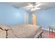 Cozy bedroom featuring hardwood floors, ceiling fan, and soft blue walls for a tranquil aesthetic at 3217 Partridge Point Trl, Valrico, FL 33596