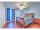 Comfortable bedroom with hardwood floors, ceiling fan, and blue accent wall at 3217 Partridge Point Trl, Valrico, FL 33596
