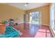 Bonus room with hardwood floors and a sliding door to the patio at 3217 Partridge Point Trl, Valrico, FL 33596