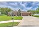 Charming single-story home with a well-manicured lawn, mature landscaping, and a three car garage at 3217 Partridge Point Trl, Valrico, FL 33596