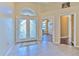 Bright foyer with decorative glass double doors, tile flooring, and arched transom window at 3217 Partridge Point Trl, Valrico, FL 33596