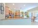 Modern kitchen with granite countertops, wooden cabinetry, and a breakfast bar overlooking the dining area at 3217 Partridge Point Trl, Valrico, FL 33596