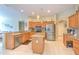 Well-lit kitchen with granite countertops, stainless appliances, and ample cabinet space at 3217 Partridge Point Trl, Valrico, FL 33596