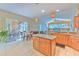 Bright kitchen with island, stainless appliances, and access to outdoor dining area at 3217 Partridge Point Trl, Valrico, FL 33596