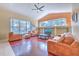 Bright living room with hardwood floors, a large window, a ceiling fan, and lots of seating at 3217 Partridge Point Trl, Valrico, FL 33596
