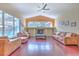 Bright living room with vaulted ceilings, hardwood floors, and large windows overlooking the pool at 3217 Partridge Point Trl, Valrico, FL 33596