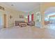 Bright open-concept living area with tile floors, living room, and a dining area with an arched doorway at 3217 Partridge Point Trl, Valrico, FL 33596