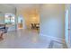Inviting living space with tile floors and an open layout, dining area, and arched doorway to kitchen at 3217 Partridge Point Trl, Valrico, FL 33596