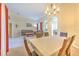 Spacious living and dining area with tile floors and modern chandelier lighting at 3217 Partridge Point Trl, Valrico, FL 33596