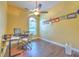Home office with wooden flooring, a ceiling fan, and natural light at 3217 Partridge Point Trl, Valrico, FL 33596
