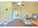 Dedicated office space with wooden flooring, ceiling fan, and ample natural light at 3217 Partridge Point Trl, Valrico, FL 33596