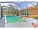 Beautiful pool area with lush landscaping and enclosed screen to avoid insects at 3217 Partridge Point Trl, Valrico, FL 33596