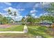 Community entrance with signage, mature landscaping, a gazebo, and an American flag at 3217 Partridge Point Trl, Valrico, FL 33596