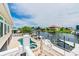 Backyard featuring a pool, spa, deck, and dock on the waterfront at 3545 Seaway Dr, New Port Richey, FL 34652