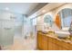 Modern bathroom with dual sinks, granite countertops, and a walk-in shower at 3545 Seaway Dr, New Port Richey, FL 34652