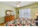 Bedroom with a ceiling fan, shuttered windows and a dresser with mirror at 3545 Seaway Dr, New Port Richey, FL 34652