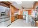 Bright kitchen with stainless steel appliances, tile flooring, and ample cabinet space at 3545 Seaway Dr, New Port Richey, FL 34652