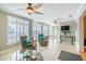 Light-filled sunroom with tile flooring, ceiling fan, and comfortable seating at 3545 Seaway Dr, New Port Richey, FL 34652