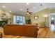 Well-lit living room featuring a fan, fireplace, and an open layout at 3545 Seaway Dr, New Port Richey, FL 34652