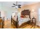 Comfortable main bedroom featuring wood floors and a ceiling fan at 3545 Seaway Dr, New Port Richey, FL 34652
