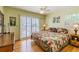 Lovely bedroom featuring hardwood floors, bright sunny window, and a comfortable bed at 3545 Seaway Dr, New Port Richey, FL 34652