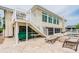 Outdoor patio featuring a grill, hot tub, seating, and staircase to the upper deck at 3545 Seaway Dr, New Port Richey, FL 34652
